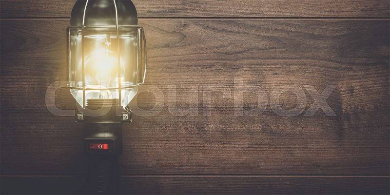 Hand lamp on the brown wooden background, stock photo
