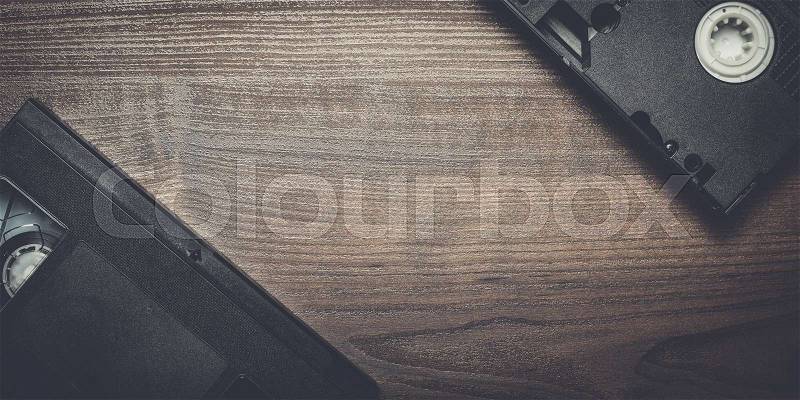 Old retro video tape on the wooden background, stock photo
