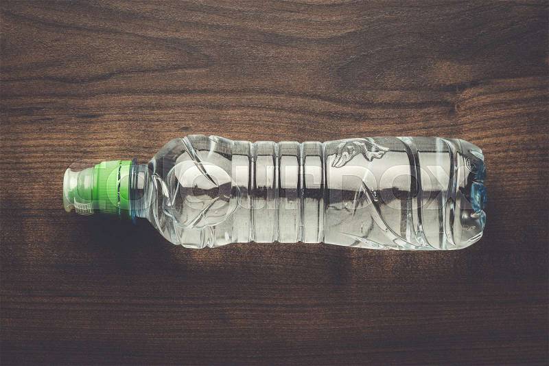 Plastic water bottle on the wooden table, stock photo