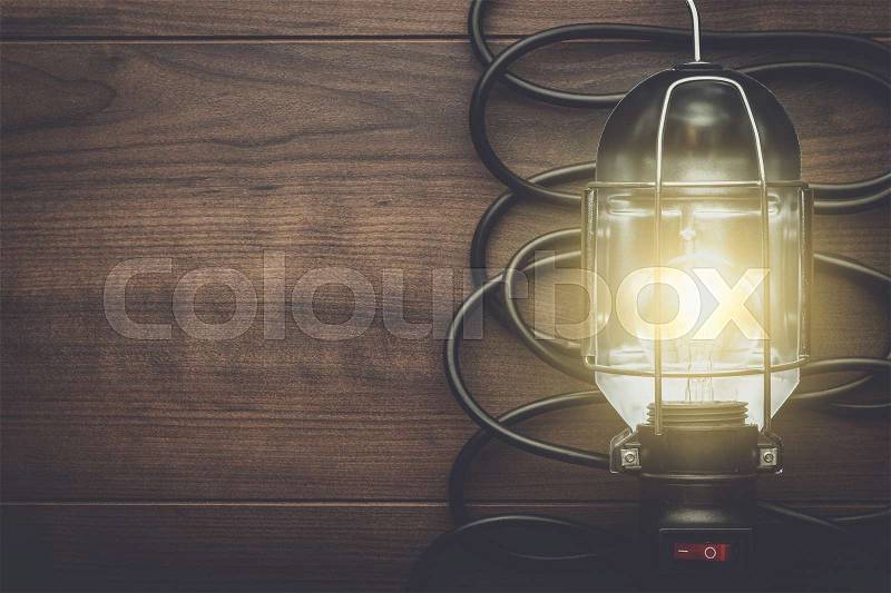 Hand lamp on the brown wooden background, stock photo