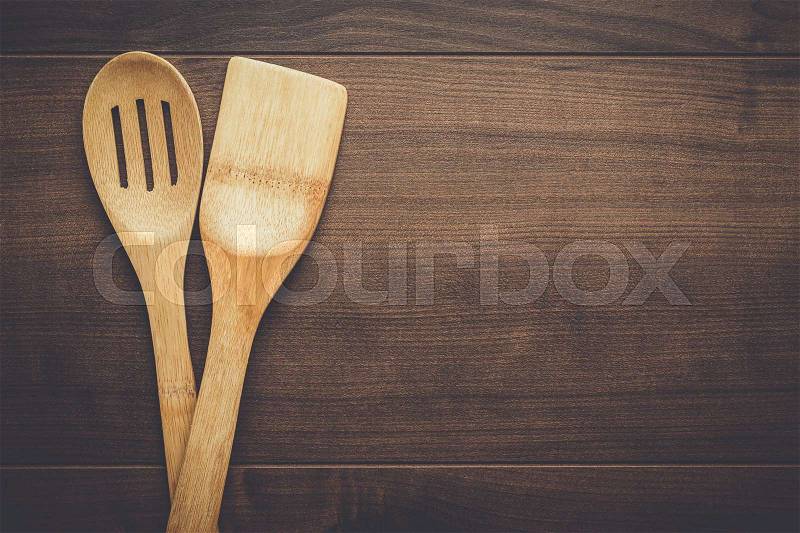 Wooden skimmer and spatula, kitchen tools on the table with copy space, stock photo