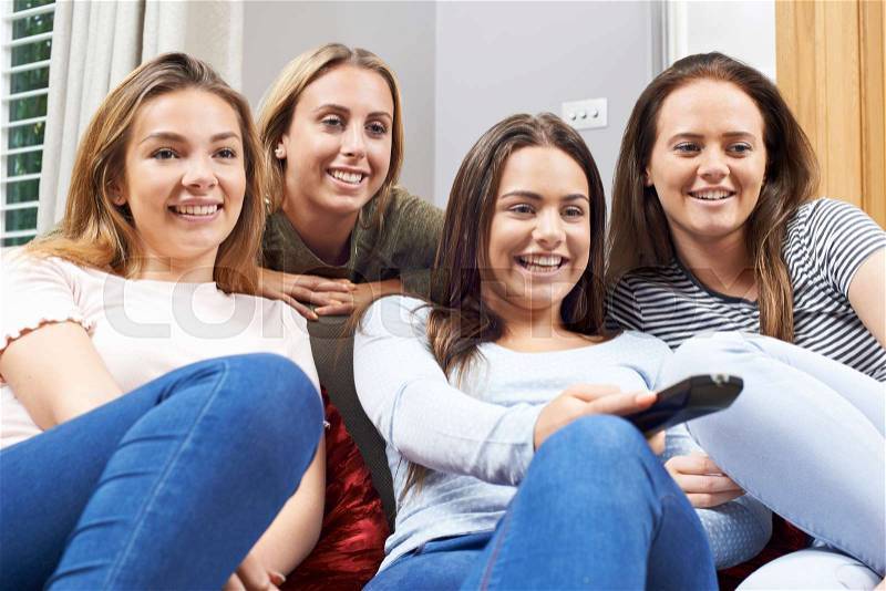 Group Of Teenage Girls Watching TV At Home Together, stock photo