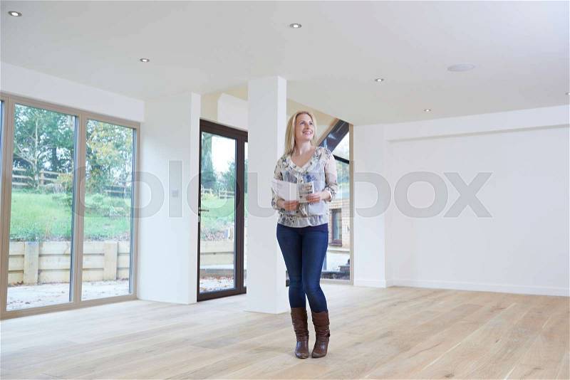 Woman Looking At Details For Property She Hopes To Buy, stock photo