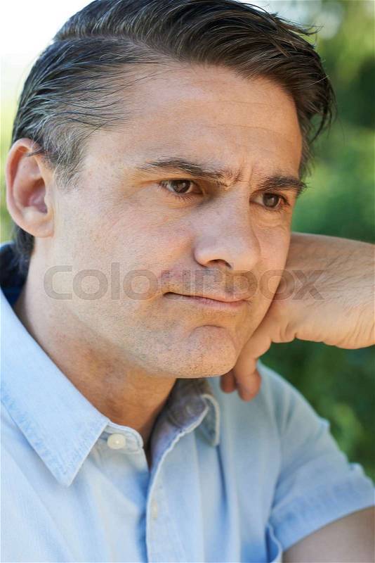 Head And Shoulders Portrait Of Concerned Mature Man, stock photo