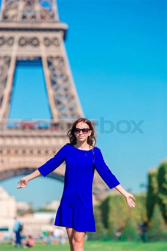 Beautiful woman in Paris background the Eiffel tower during summer vacation, stock photo