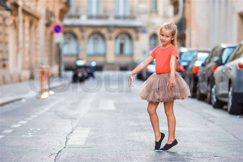Adorable little girl during summer vacation in Paris. Amazing balerina enjoy her trip in France, stock photo