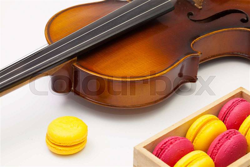 Music break - Old violin and traditional french colorful macarons, stock photo