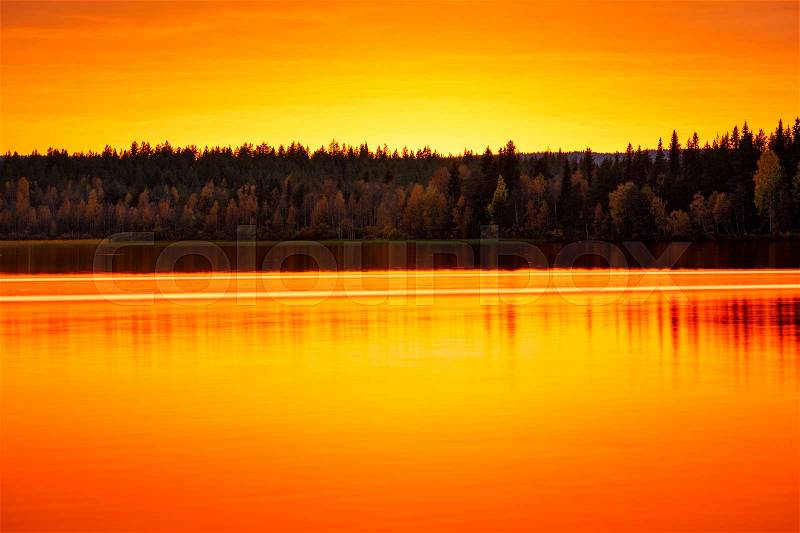 Orange sunset on the lake, Finland, stock photo