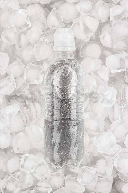Plastic water bottle is cooling in the ice, stock photo