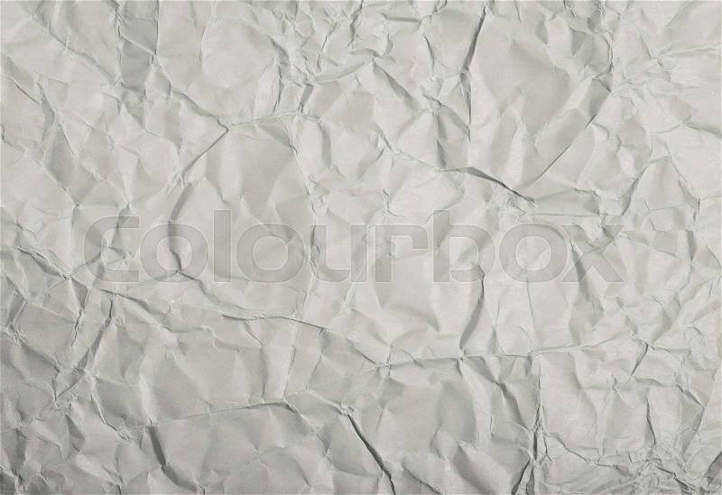 Close-up fragment of a gray crumpled paper texture as a backdrop composition, stock photo
