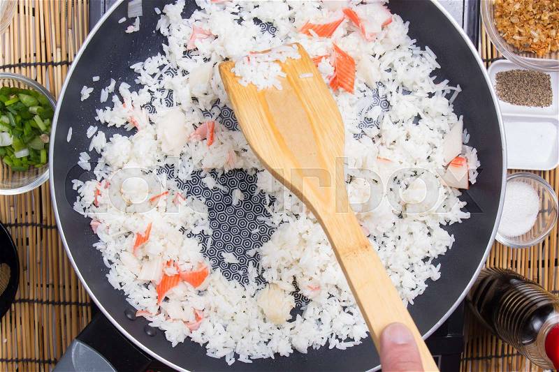 Chef cooking rice in pan / cooking fired rice concept, stock photo