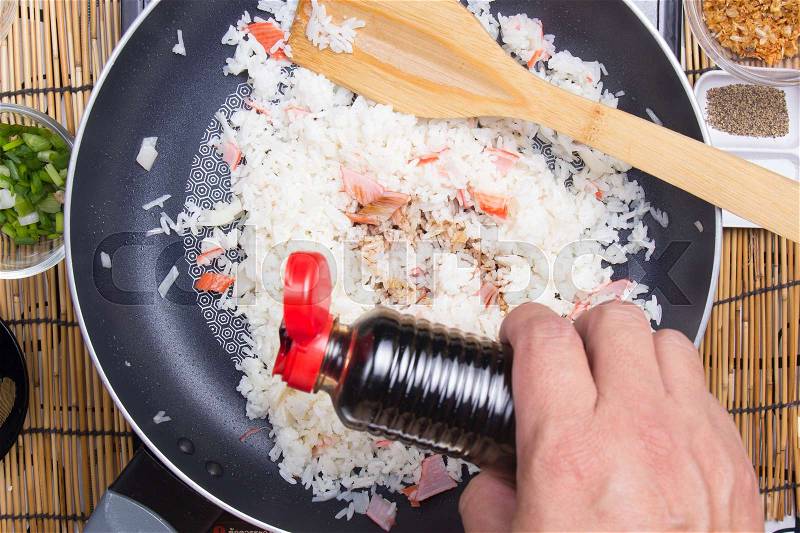 Chef putting soy sauce for cooking rice / cooking fired rice concept, stock photo
