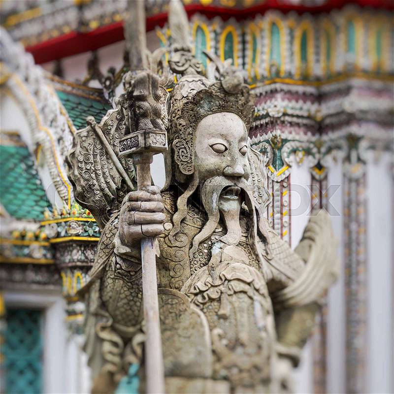 Statue of a Chinese warrior near an entrance of Wat Pho. Wat Pho is a Buddhist temple complex in the Rattanakosin district of Bangkok, stock photo