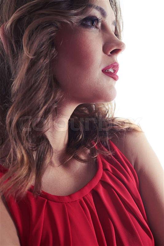 Side view of dreamy female with evening make-up gazing sideward. Dazzling look somewhere. Young Caucasian woman posing at the camera , stock photo
