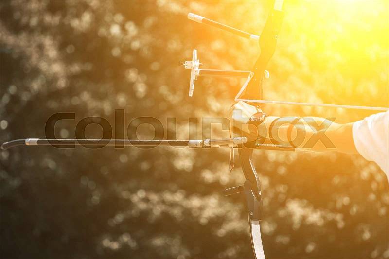 Athlete aiming at a target and shoots an arrow. Archery, stock photo