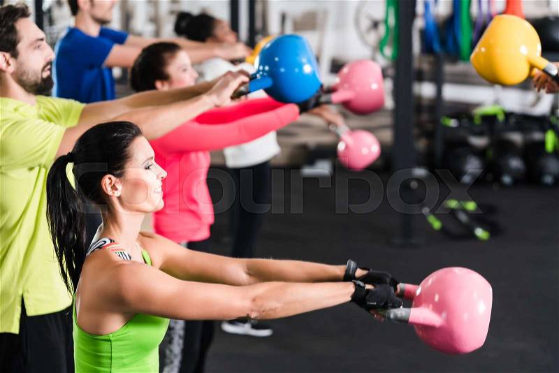 Functional fitness workout in sport gym with kettlebell, stock photo