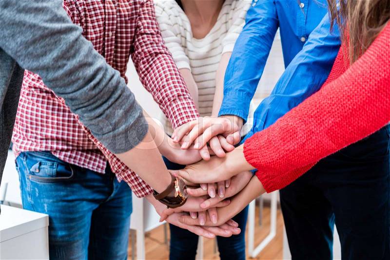 Students in college stacking hand together, being a team, stock photo