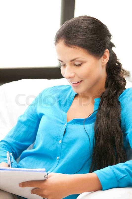Picture of happy woman with big notepad, stock photo