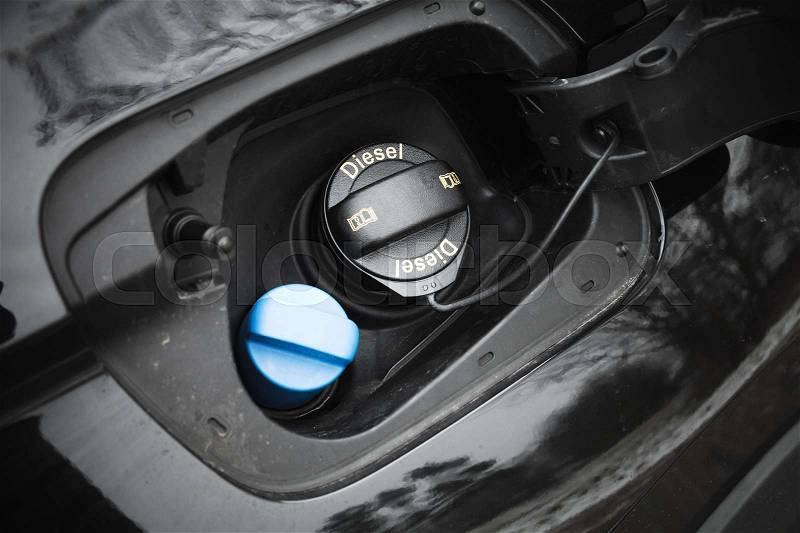 Modern car details, closed fuel cap with Diesel text marking, stock photo