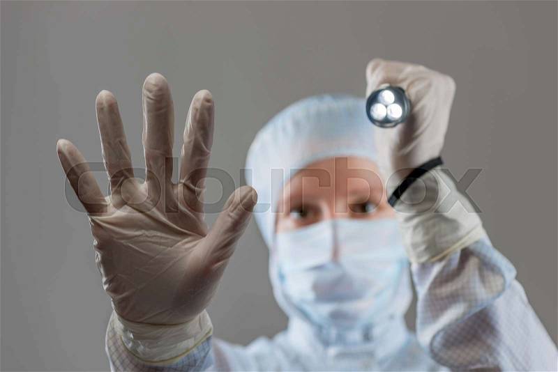 Portrait of a man in protective suit with a flashlight in his hand, stock photo