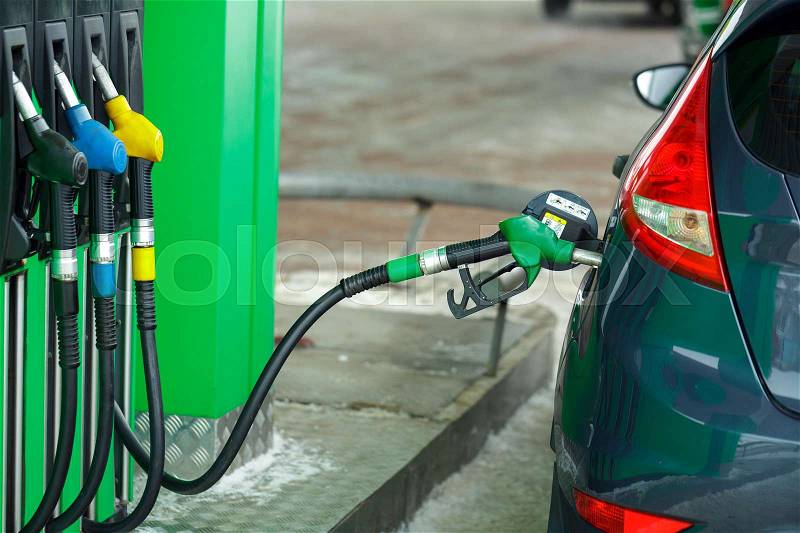 Car refueling on a petrol station in winter closeup, stock photo