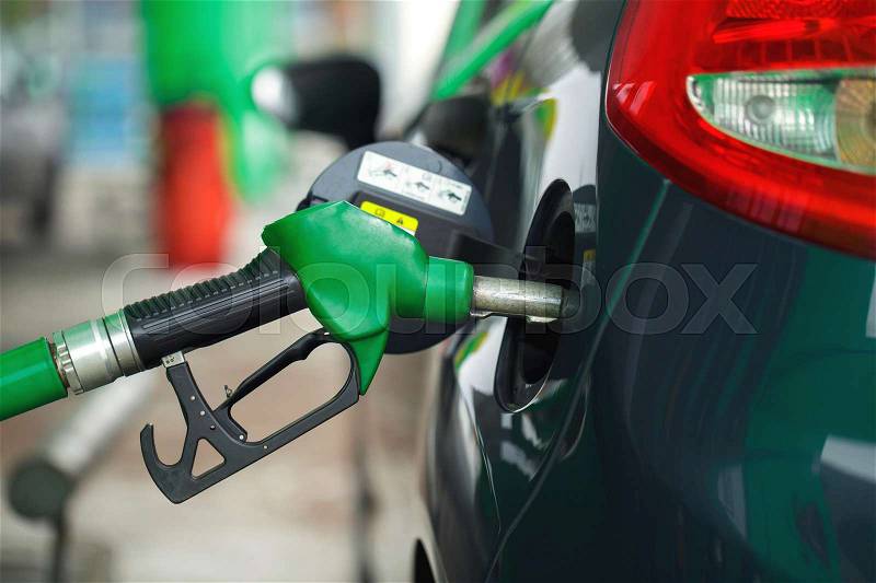 Car refueling on a petrol station in winter closeup, stock photo