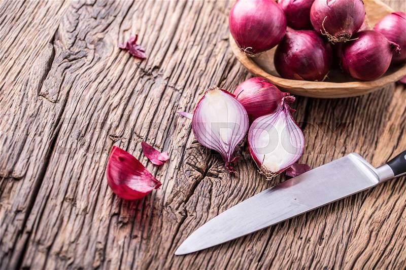 Onion. Red onions on very old oak wood board. Selective focus, stock photo