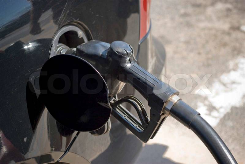 At the gas pump - filling up the tank, stock photo