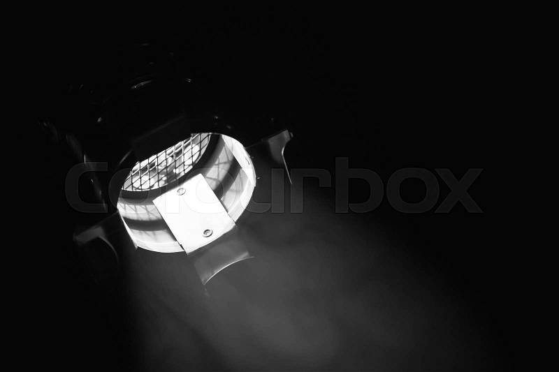 Classical spot light in metal body over black background, stage illumination equipment, stock photo