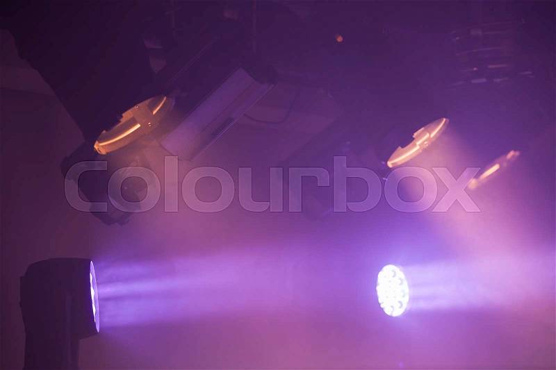 Colorful spot lights with strong beams in smoke, stage illumination background photo, stock photo