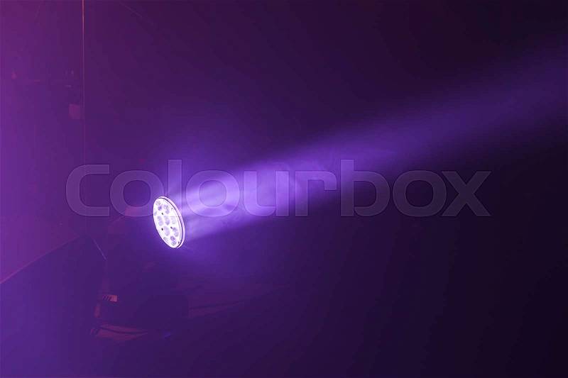 Stage LED spot light with purple beam, stage illumination equipment, stock photo
