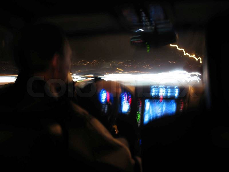 Driving at night in a modern luxury car, stock photo