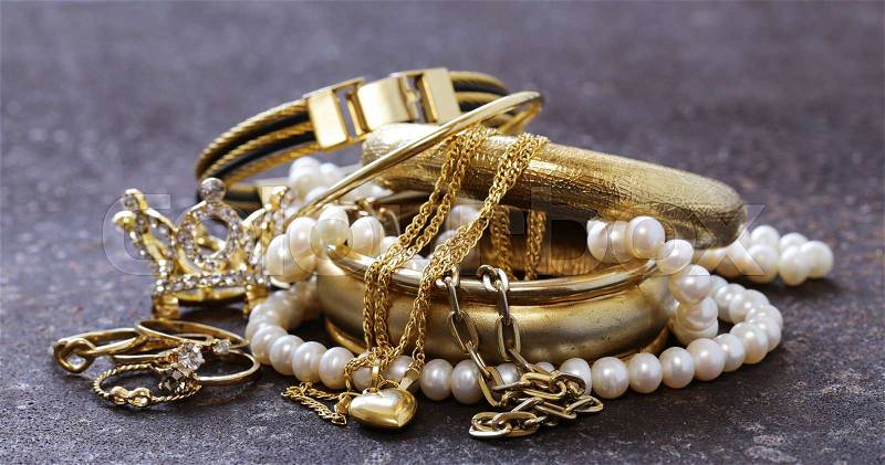 Gold jewelry and pearls, bracelets and chains, stock photo