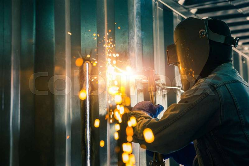 Worker cutting steel sheet by gas cutting, repair container box job. , stock photo