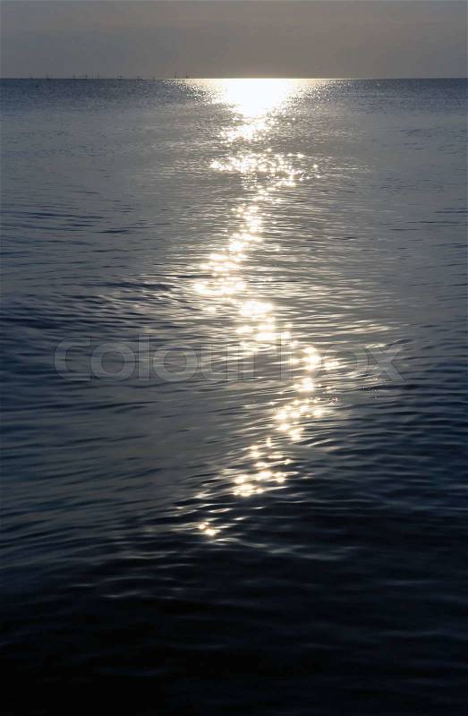 Moonlight path on night sea water surface, stock photo