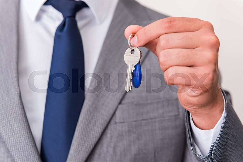 Businessman in real estate concept with home key, stock photo