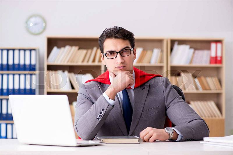 Superhero businessman working in the office, stock photo