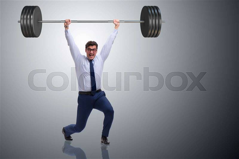 Businessman with barbell in heavy lifting concept, stock photo