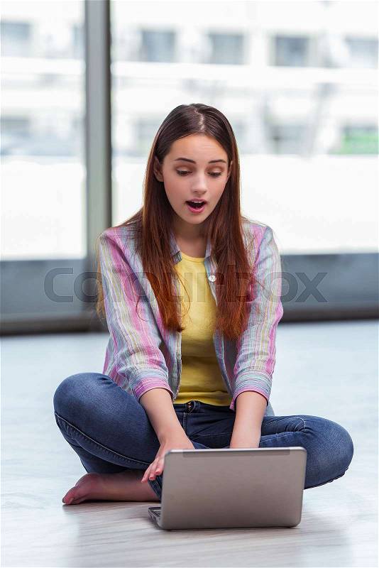 Young girl surfing internet on laptop, stock photo