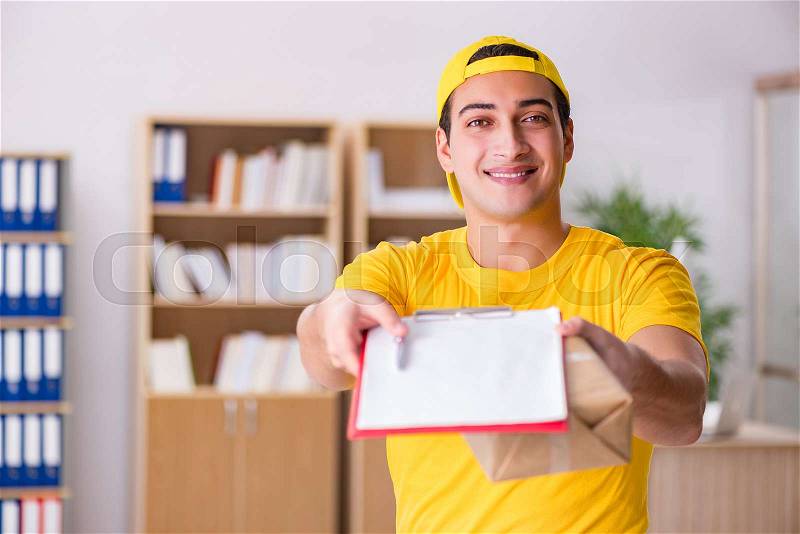 Delivery man delivering parcel box, stock photo