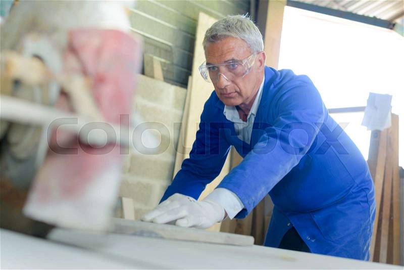 Senior manual worker at work, stock photo
