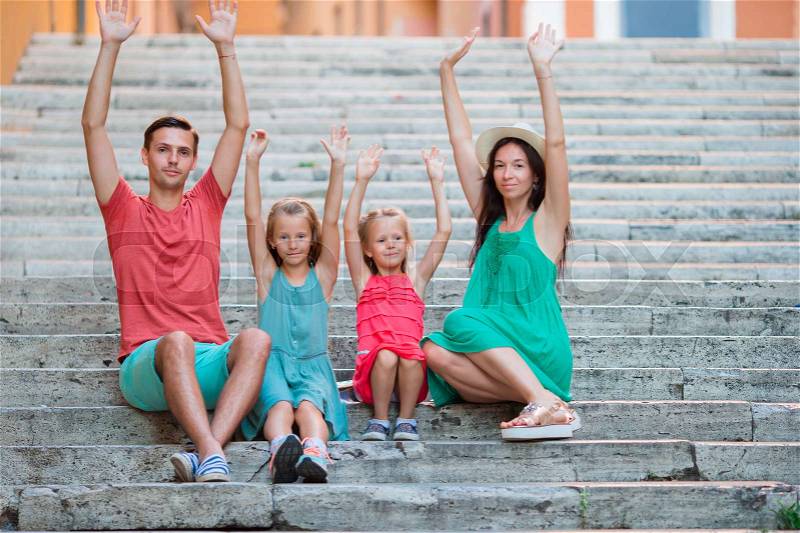 Family vacation in Europe. Parents and kids on steps in Rome, stock photo