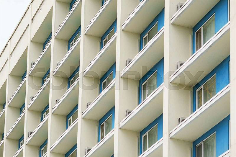Part of a modern multi-storey office building with balconies and windows, stock photo
