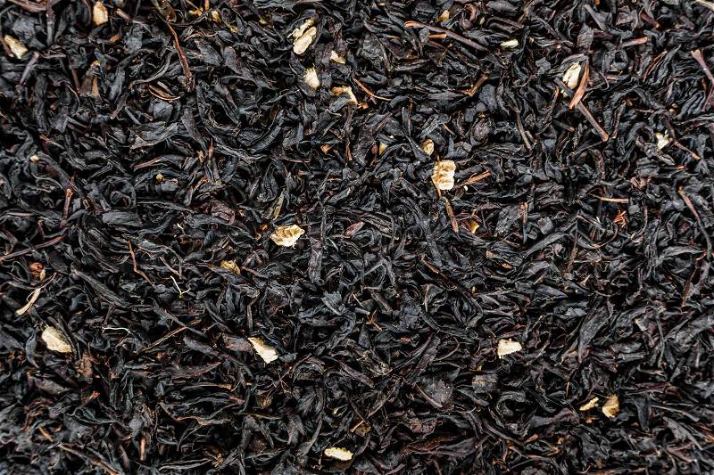 Black tea background. Heap of dry black tea, stock photo