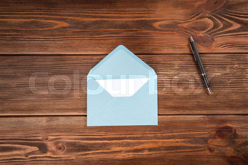 Envelope with a letter on wooden table, stock photo