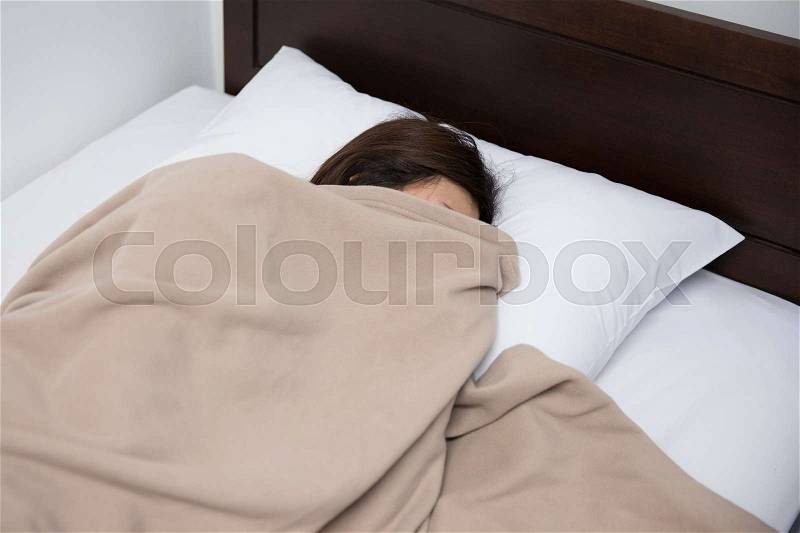 Asian woman sleeping on bed, stock photo