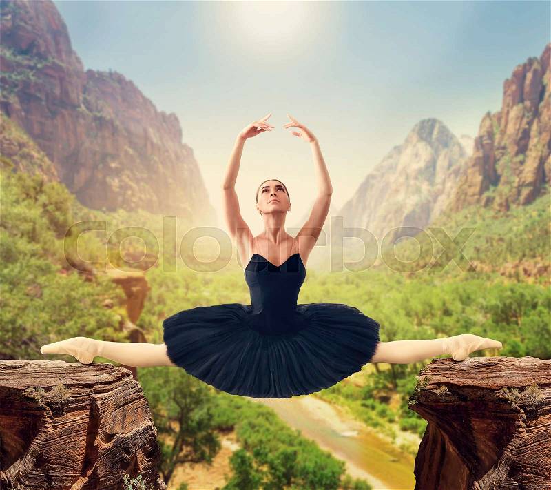 Graceful ballerina sit on the twine over the gorge, mountain valley on background, stock photo