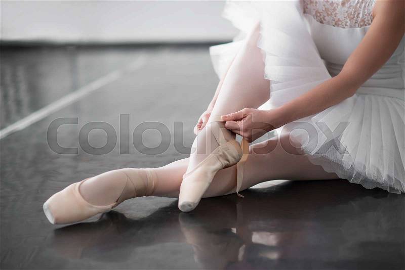 Ballet dancer legs in pointe shoes closeup. Ballerina rehearsal in class, stock photo