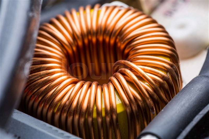 Electric transformer copper coil closeup. Electrical component, stock photo
