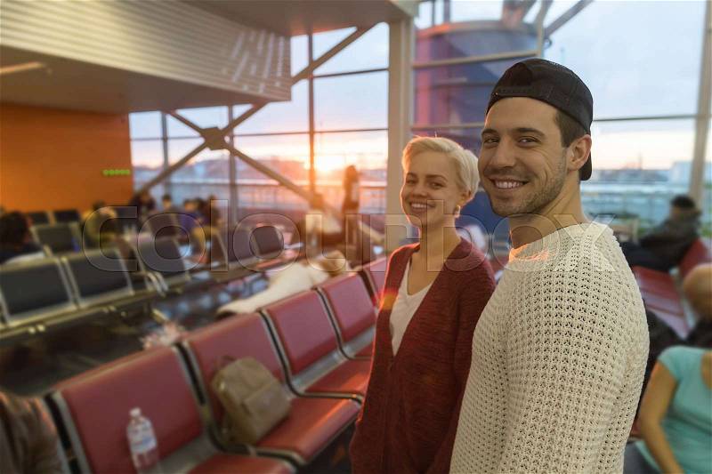 Young Couple In Airport Lounge Waiting Departure Happy Smile Man And Woman Flight, stock photo